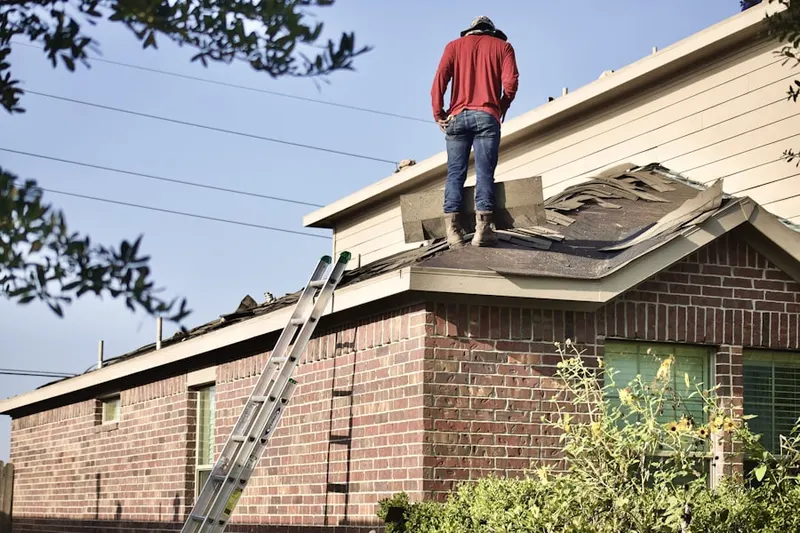 Professional roofer working on a residential roof in Lyndon